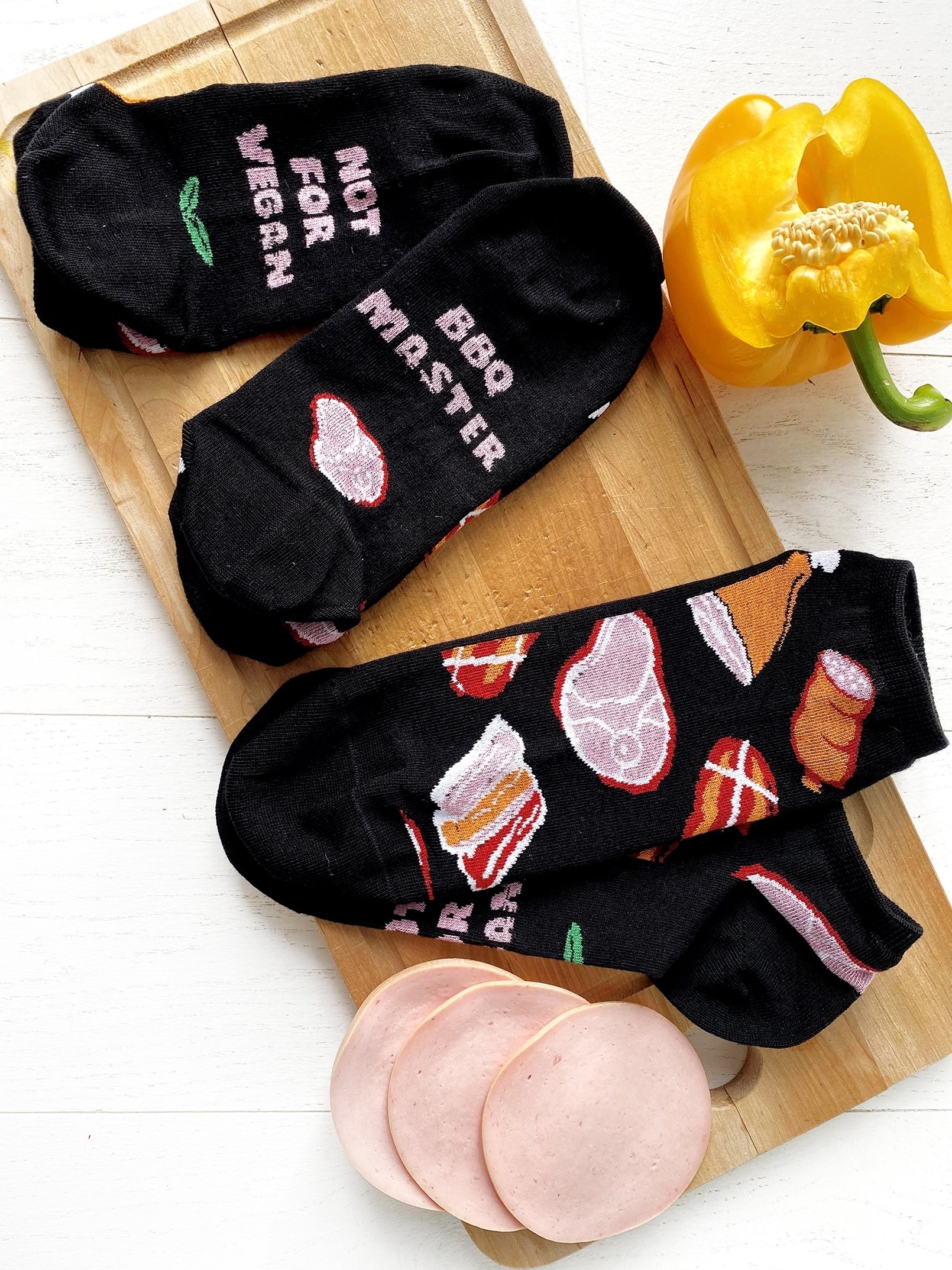 MEAT MARKET black low-cut chef socks featuring unique patterns and playful writings on the soles.