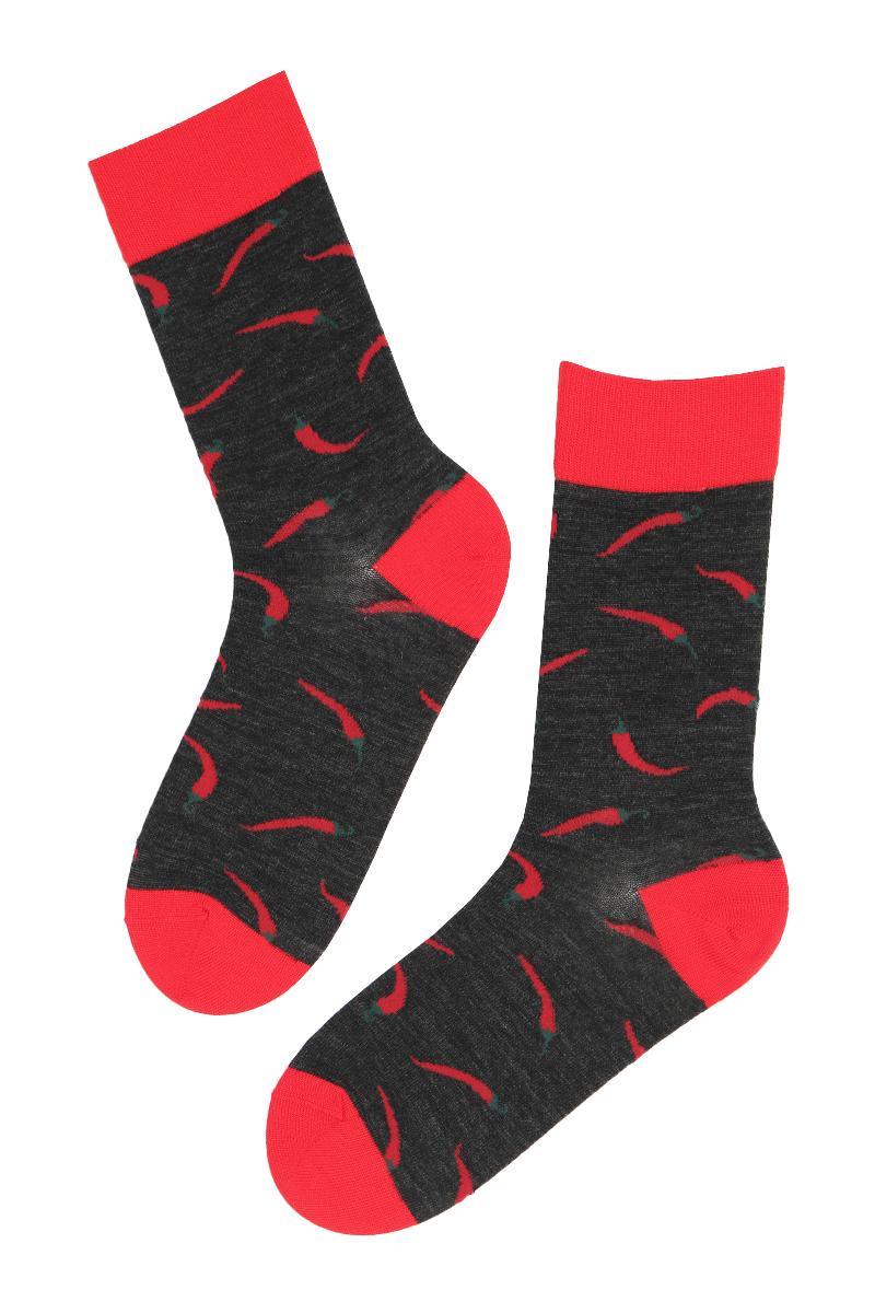 PEPPER merino wool socks in black and red with a chilli design, showcasing their soft texture and stylish appearance.