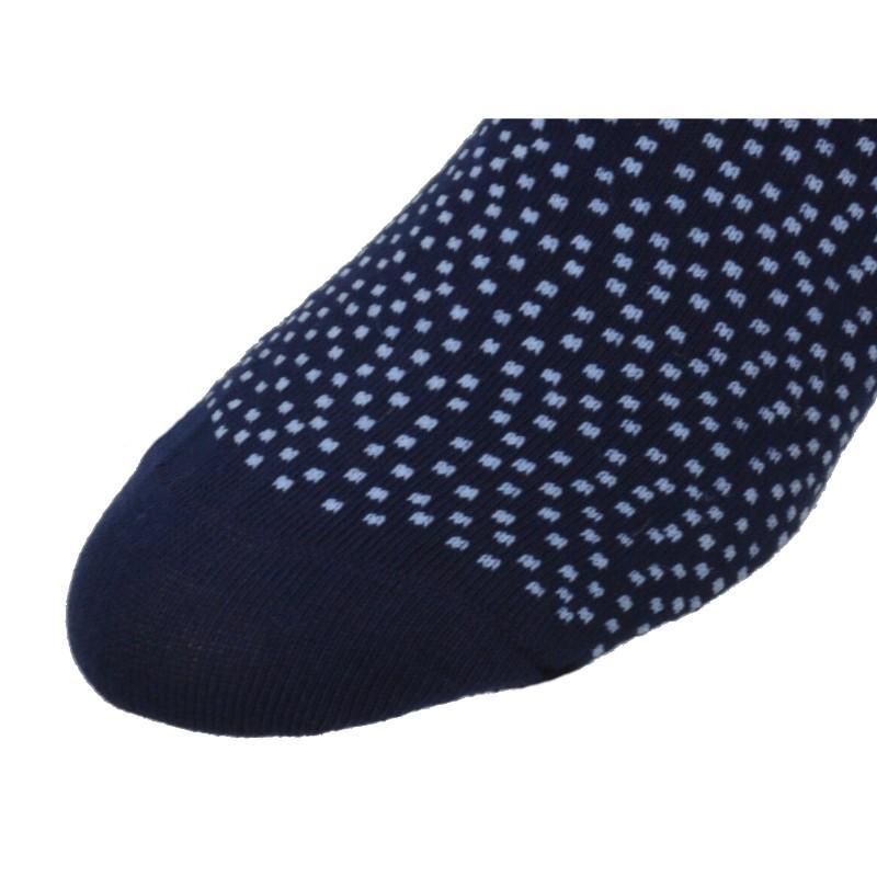 A pair of stylish socks featuring a pin dot pattern and a solid color, made from soft combed cotton with a rib knit cuff.