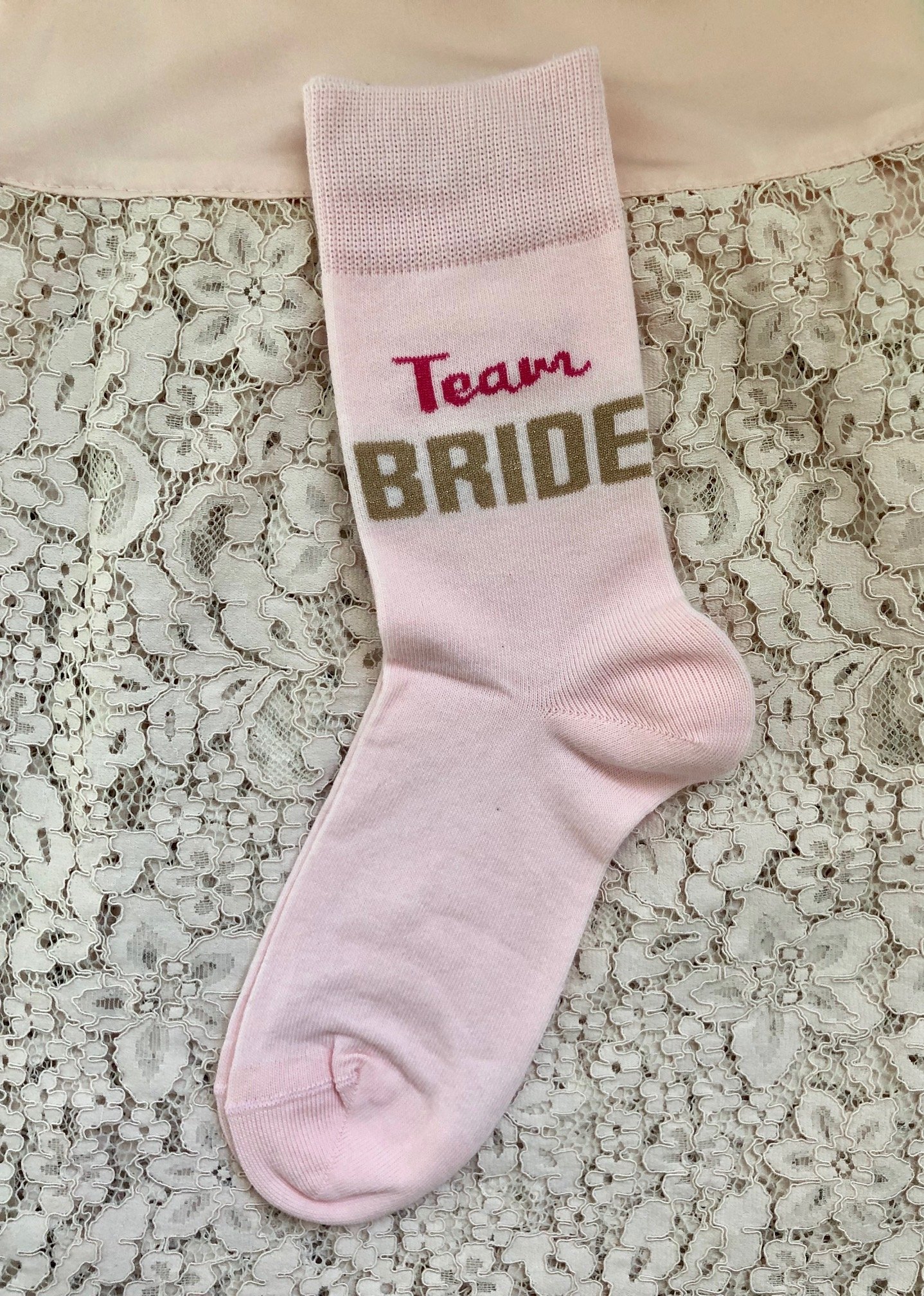 Cozy pink women's socks with 'TEAM BRIDE' text, perfect for hen parties.