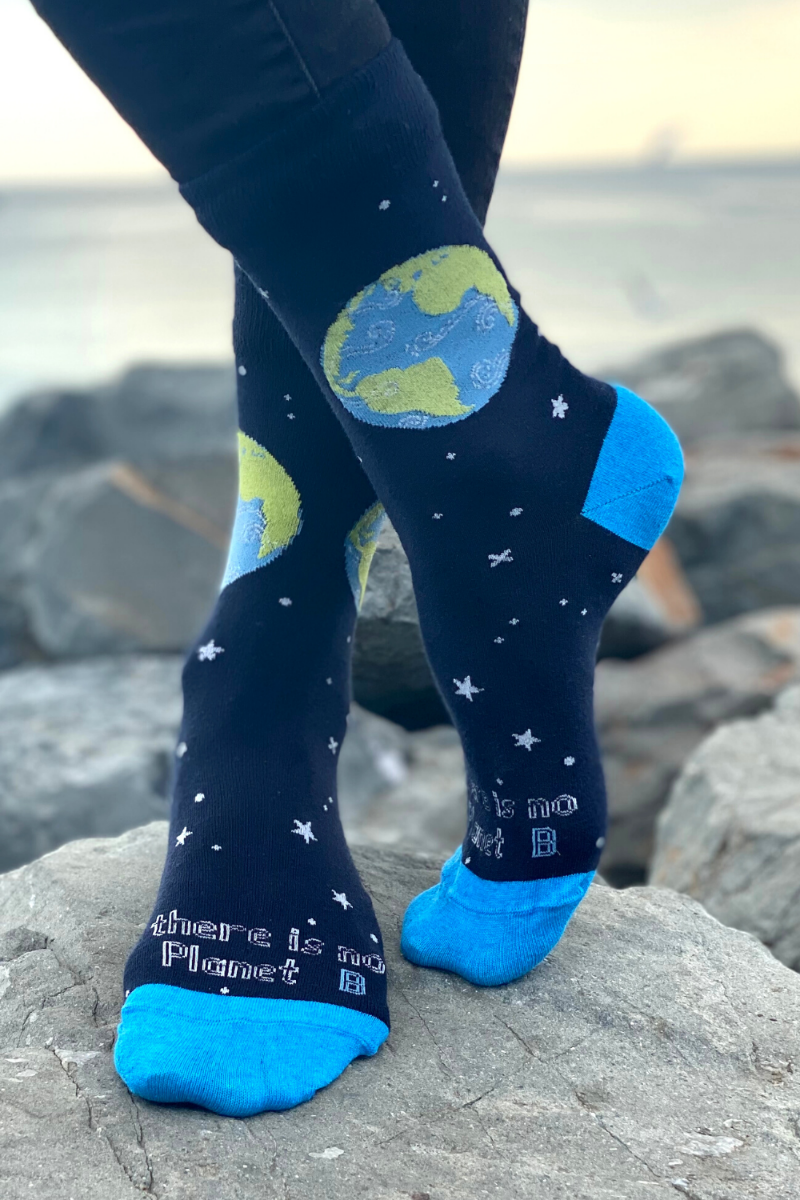 PLANET B blue cotton socks featuring a globe and stars design, made from recycled yarn, with the phrase 'THERE IS NO PLANET B'.