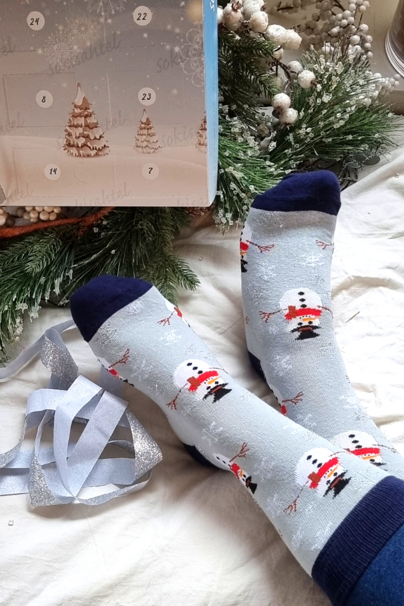 A pair of light gray cotton socks featuring a playful snowman pattern, perfect for winter wear.