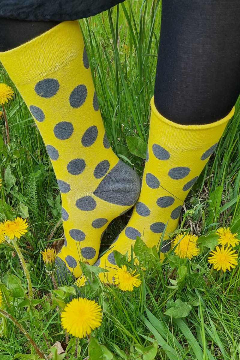 Bright yellow SUMMER cotton socks with playful dots, made from recycled materials, showcasing eco-friendly fashion.