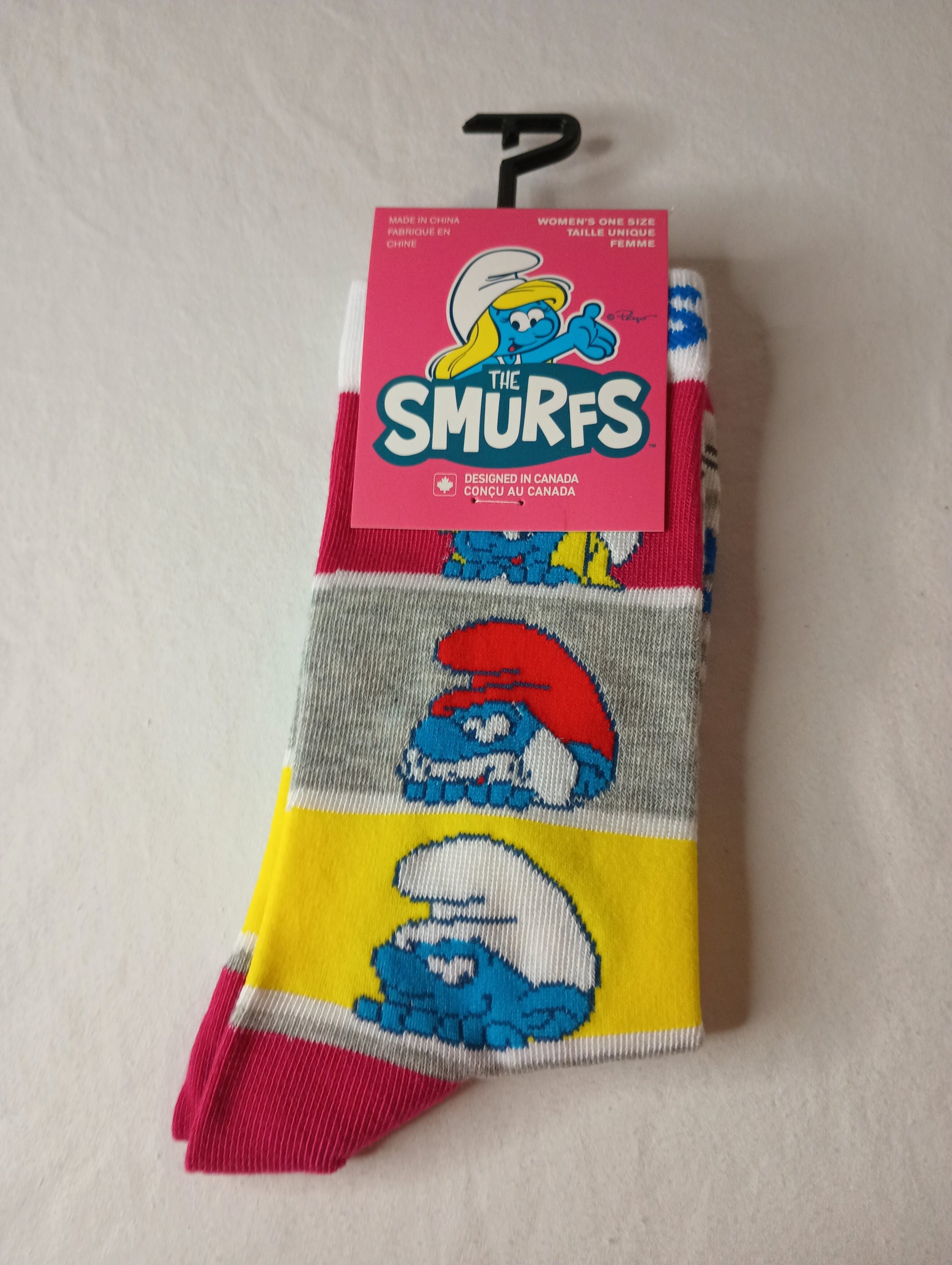 A pair of THE SMURFS Crew Socks in grey and white, featuring playful Smurfs designs, suitable for women's shoe sizes 6-9.5.