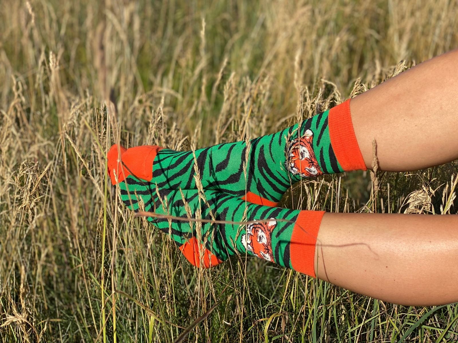 TIGER green socks featuring a playful tiger face design with elegant stripes, made from a soft cotton blend.