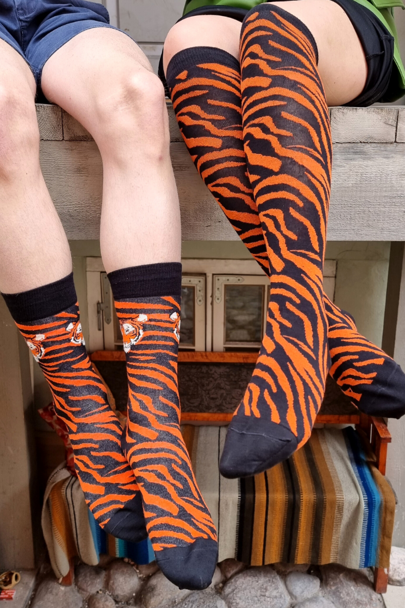 TIGER knee-highs featuring a vibrant tiger pattern in black and orange, showcasing elegant stripes.