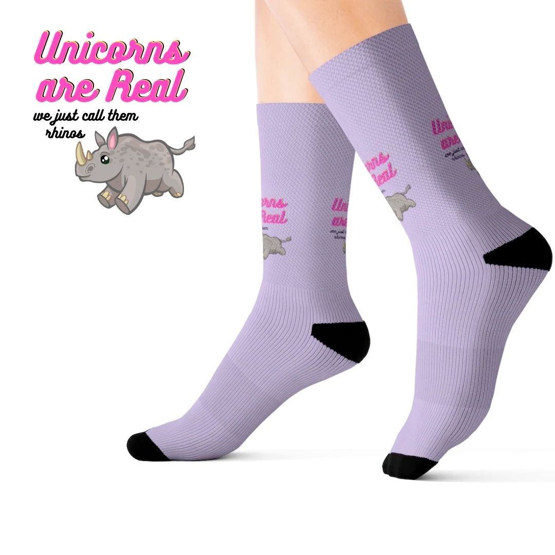 A pair of colorful novelty socks featuring a whimsical unicorn and rhino print, showcasing vibrant colors and a fun design.