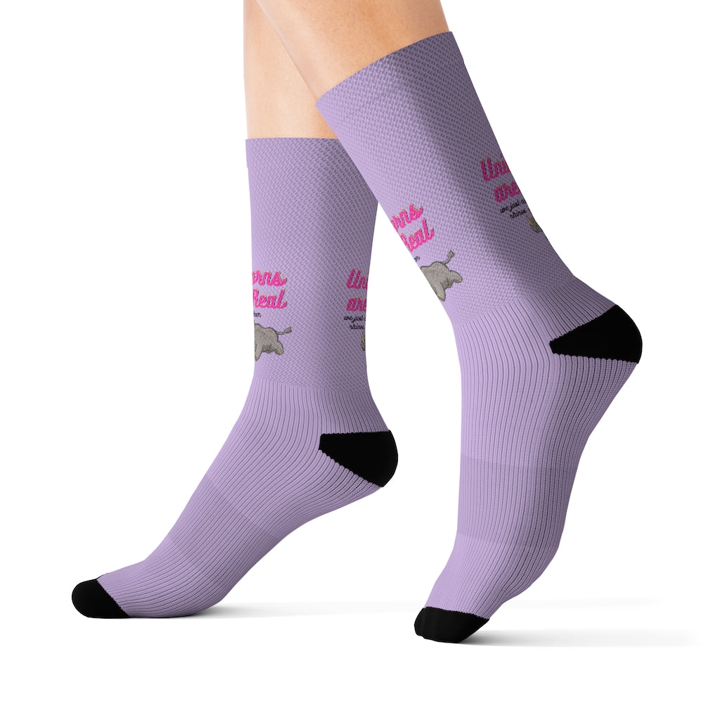 A pair of colorful novelty socks featuring a whimsical unicorn and rhino print, showcasing vibrant colors and a fun design.