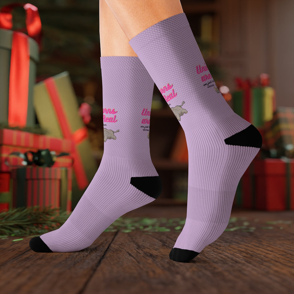 A pair of colorful novelty socks featuring a whimsical unicorn and rhino print, showcasing vibrant colors and a fun design.