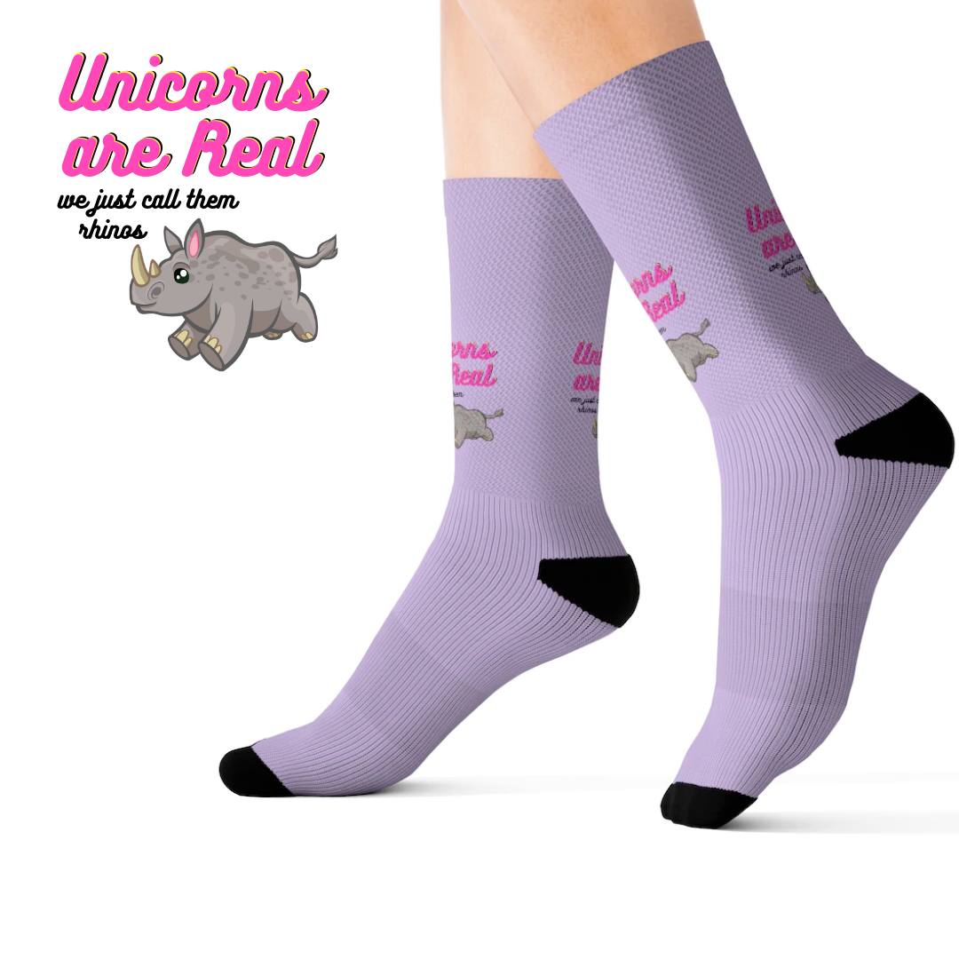 A pair of colorful novelty socks featuring a whimsical unicorn and rhino print, showcasing vibrant colors and a fun design.