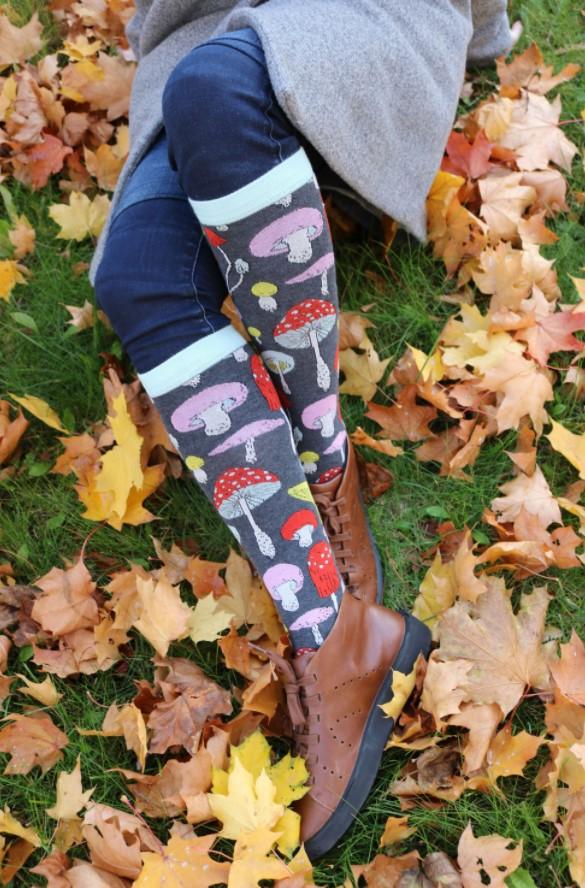 Colorful knee-high socks featuring a whimsical mushroom pattern, perfect for autumn wear.