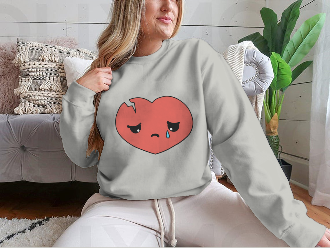 A cartoon illustration of a broken sad heart crying, symbolizing unhappy love, designed with vibrant colors and expressive features.