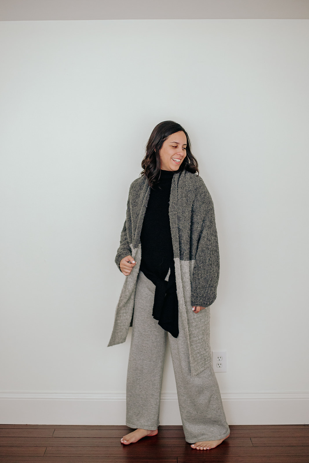 Front view of a stylish Alpaca Turtleneck Sweater with a front tie, available in Grey and Black, showcasing its oversized fit and luxurious texture.