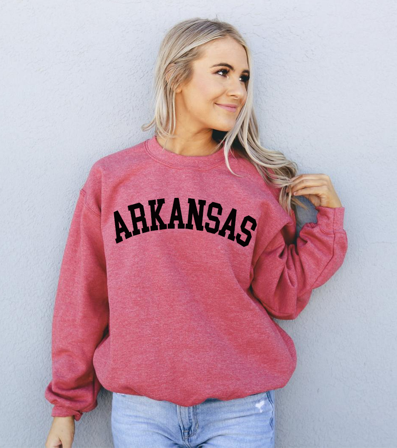 A cozy Arkansas Sweatshirt featuring a crew neck and rib-knit collar, made from soft air-jet spun yarn in a stylish unisex design.