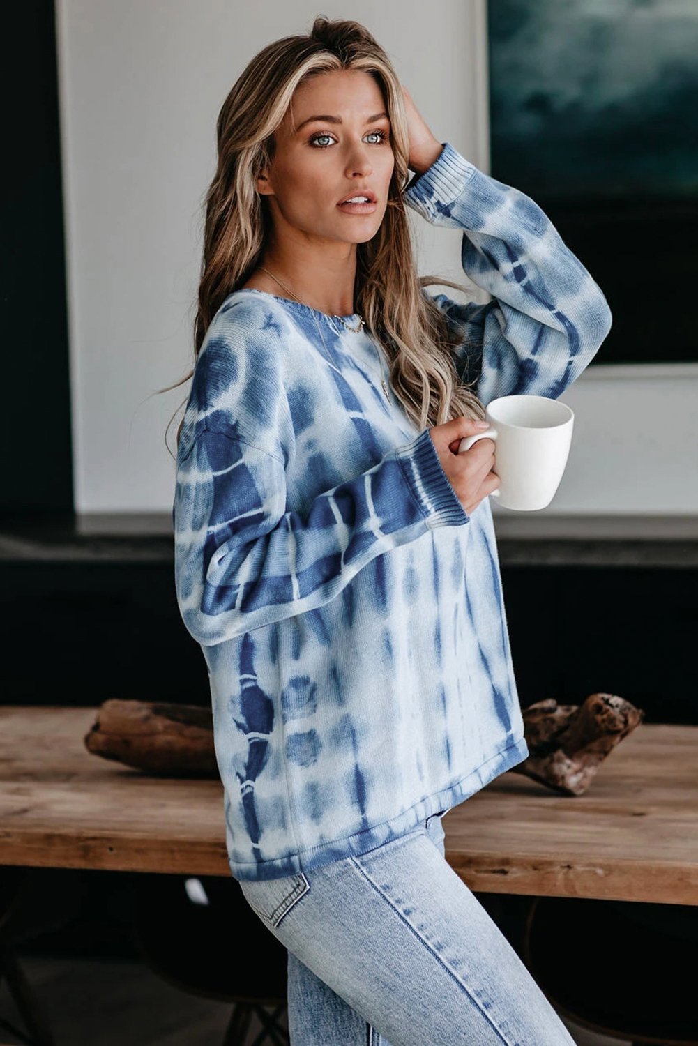 Blue and white tie-dye print knit sweater with a relaxed fit, showcasing full sleeves and a cozy chunky knit texture.