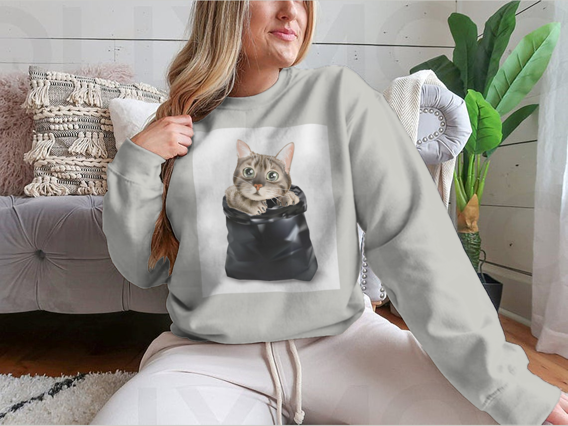 Illustration of a cute cat peeking out from a black trash bag, showcasing a whimsical and playful design.