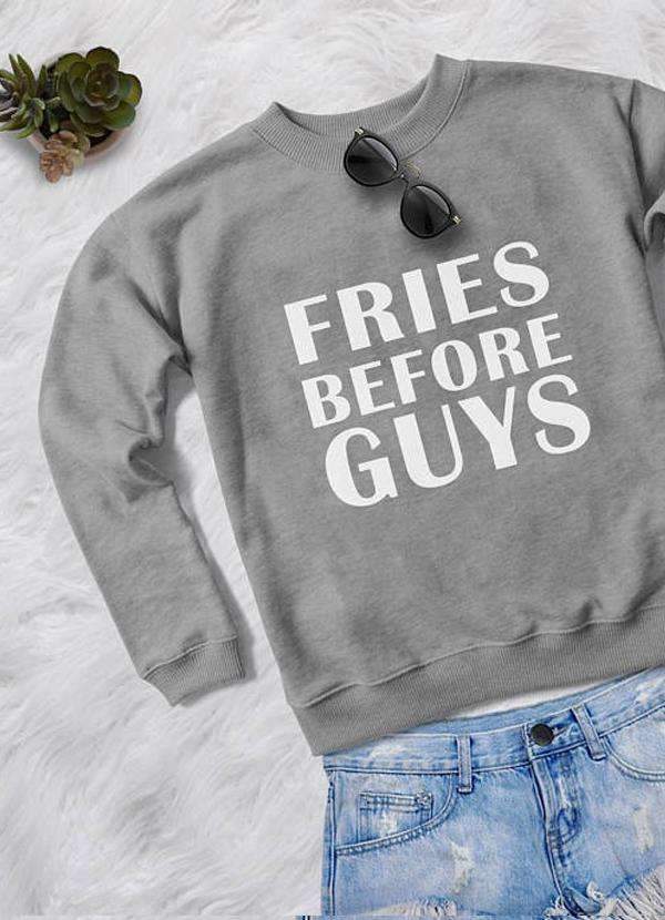 A stylish women's sweatshirt featuring the phrase 'Fries Before Guys' in a vibrant print, showcasing a unique design with colorful patterns.