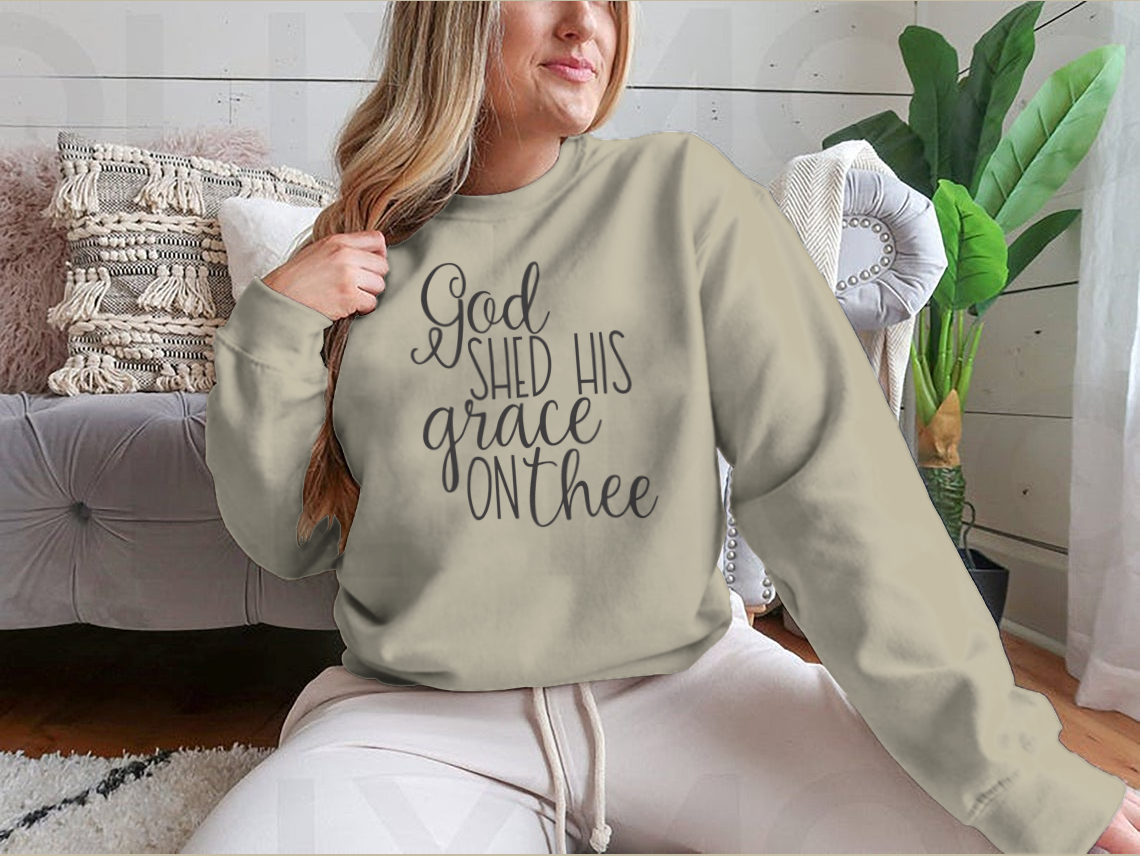 Inspirational background featuring the quote 'God Shed His Grace On Thee' on a soft cotton fabric, perfect for uplifting decor.