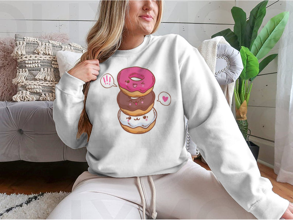 A colorful illustration of three cute kawaii donuts, perfect for T-shirt design, showcasing their playful and vibrant features.