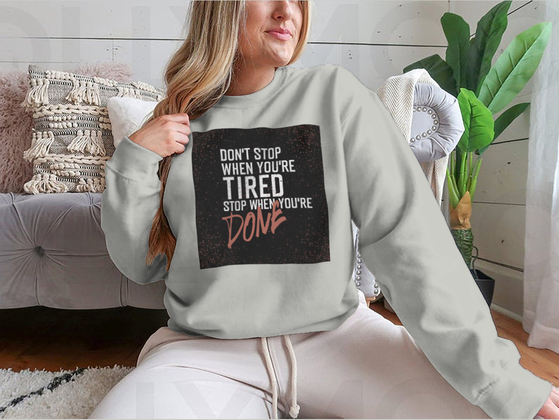 Motivational poster with the quote 'Don't Stop When You're Tired' displayed in a stylish setting, emphasizing inspiration and determination.