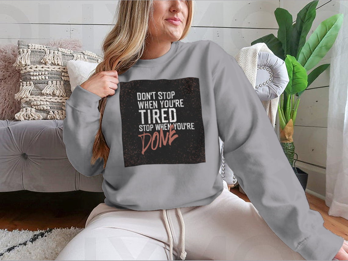 Motivational poster with the quote 'Don't Stop When You're Tired' displayed in a stylish setting, emphasizing inspiration and determination.