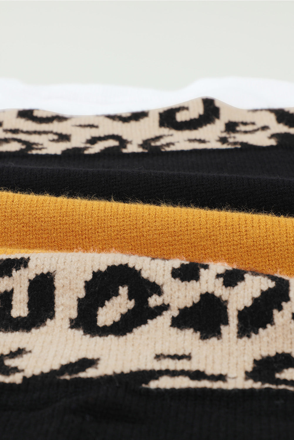 A stylish New Leopard Pullover Sweater featuring a color block design and leopard pattern, perfect for fall and winter wear.