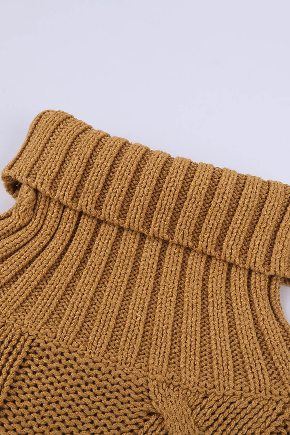 A cozy orange cable knit turtleneck sweater with an oversized fit, perfect for winter wear.