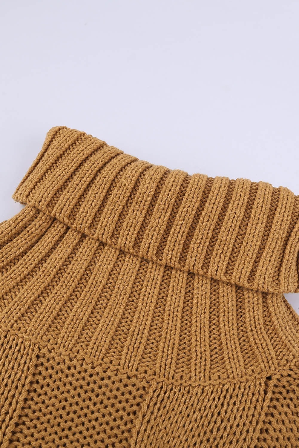 A cozy orange cable knit turtleneck sweater with an oversized fit, perfect for winter wear.