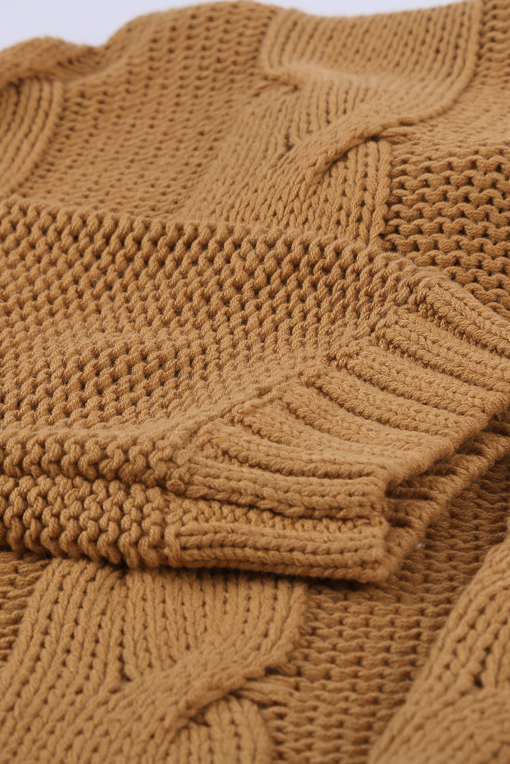 A cozy orange cable knit turtleneck sweater with an oversized fit, perfect for winter wear.
