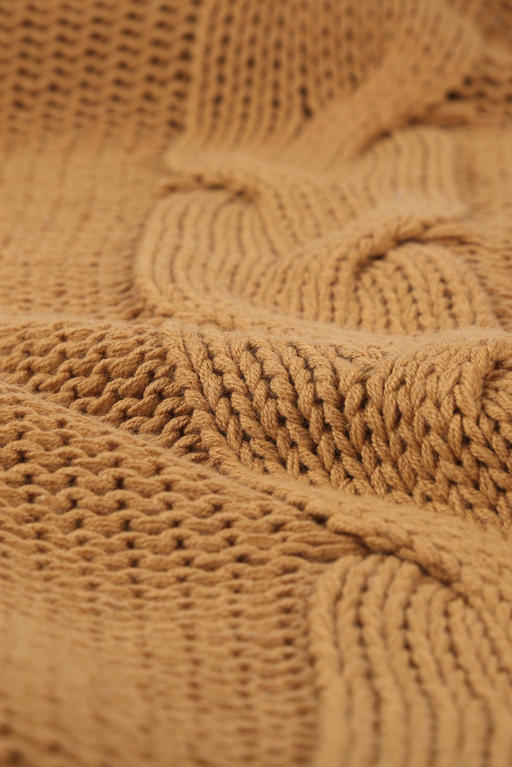 A cozy orange cable knit turtleneck sweater with an oversized fit, perfect for winter wear.