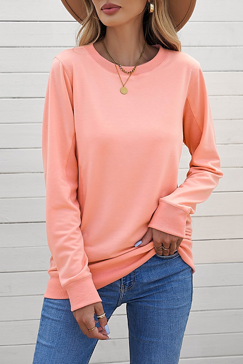 A cozy pink wash fleece sweatshirt with long sleeves, perfect for casual wear in winter, spring, and autumn.