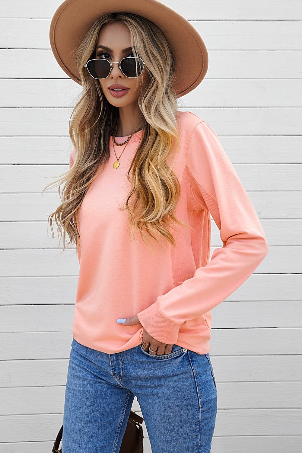 A cozy pink wash fleece sweatshirt with long sleeves, perfect for casual wear in winter, spring, and autumn.