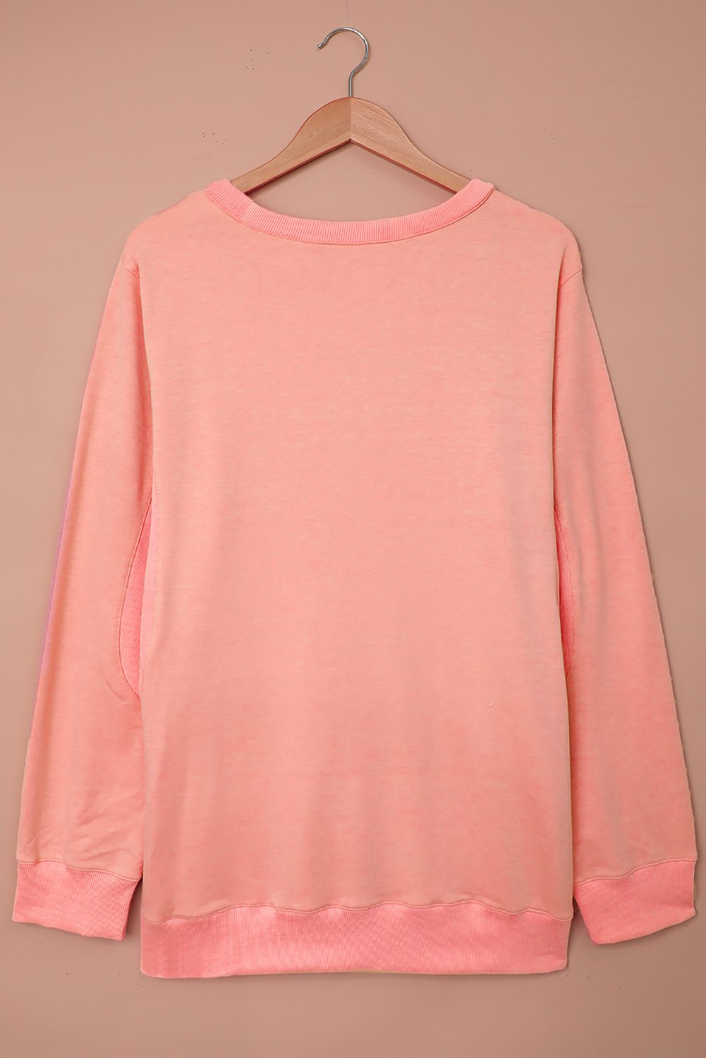 A cozy pink wash fleece sweatshirt with long sleeves, perfect for casual wear in winter, spring, and autumn.