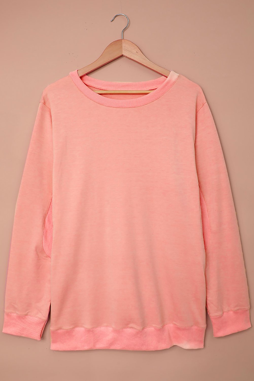 A cozy pink wash fleece sweatshirt with long sleeves, perfect for casual wear in winter, spring, and autumn.