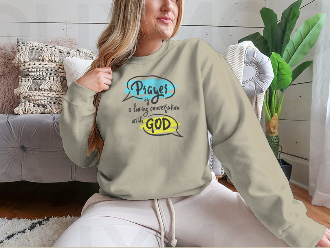 A comfortable t-shirt featuring the inspirational phrase 'Prayer Is A Loving Conversation With God' in a classic fit, made from soft cotton fabric.