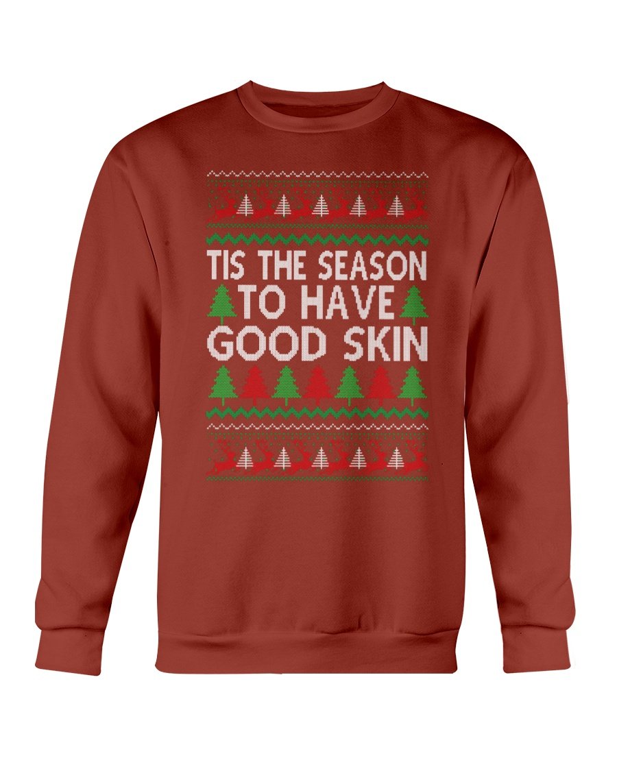 A cozy Gildan crewneck sweatshirt featuring the festive phrase 'Tis the Season to have Good Skin, perfect for Christmas celebrations.