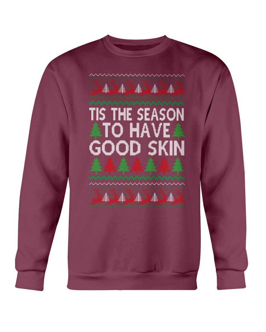 A cozy Gildan crewneck sweatshirt featuring the festive phrase 'Tis the Season to have Good Skin, perfect for Christmas celebrations.