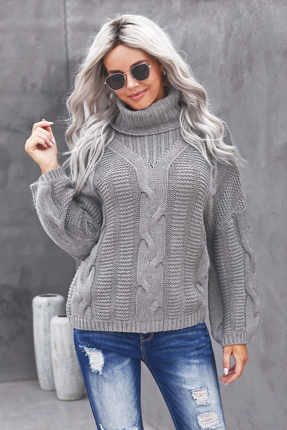 A cozy Winter Gray Oversize Turtleneck Textured Sweater displayed on a mannequin, showcasing its chunky knit design and elegant turtleneck.
