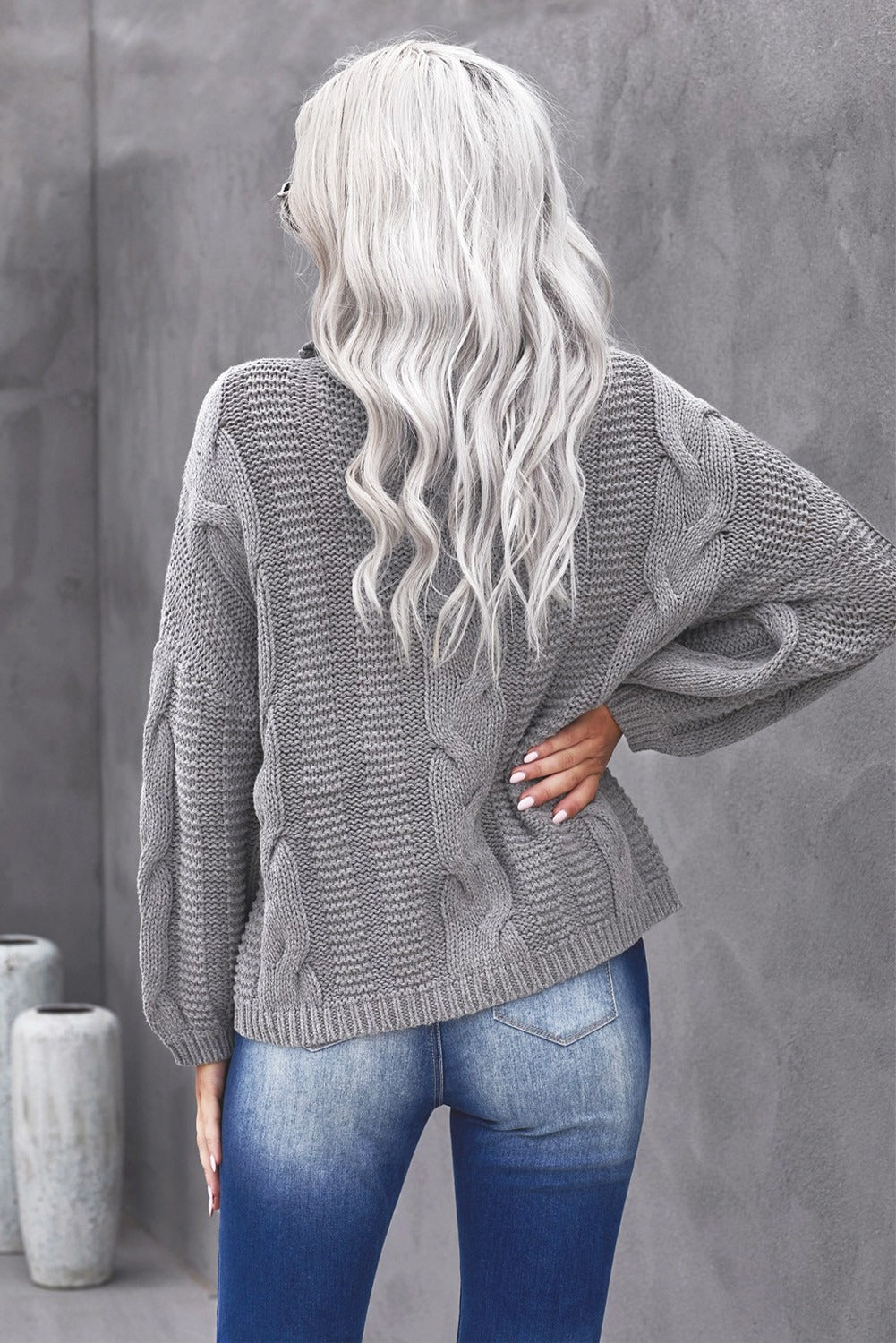 A cozy Winter Gray Oversize Turtleneck Textured Sweater displayed on a mannequin, showcasing its chunky knit design and elegant turtleneck.
