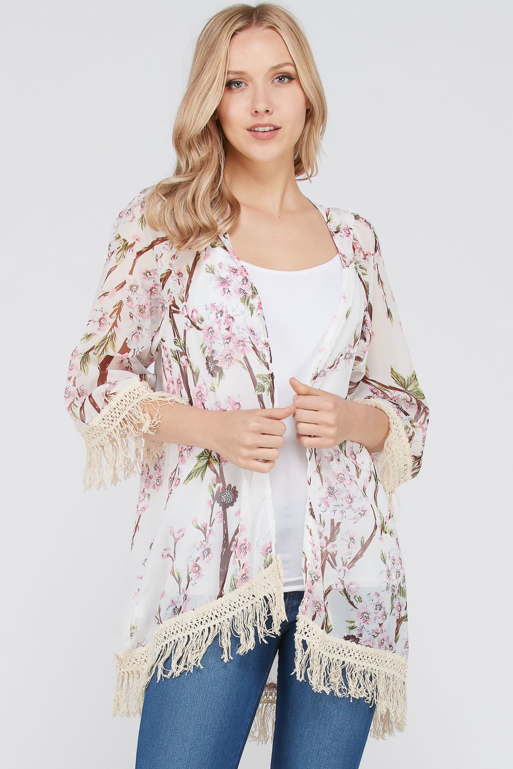 A stylish Women's 3/4 Sleeve Floral Printed Fringe Cardigan featuring a vibrant floral pattern and trendy fringe detailing at the bottom.