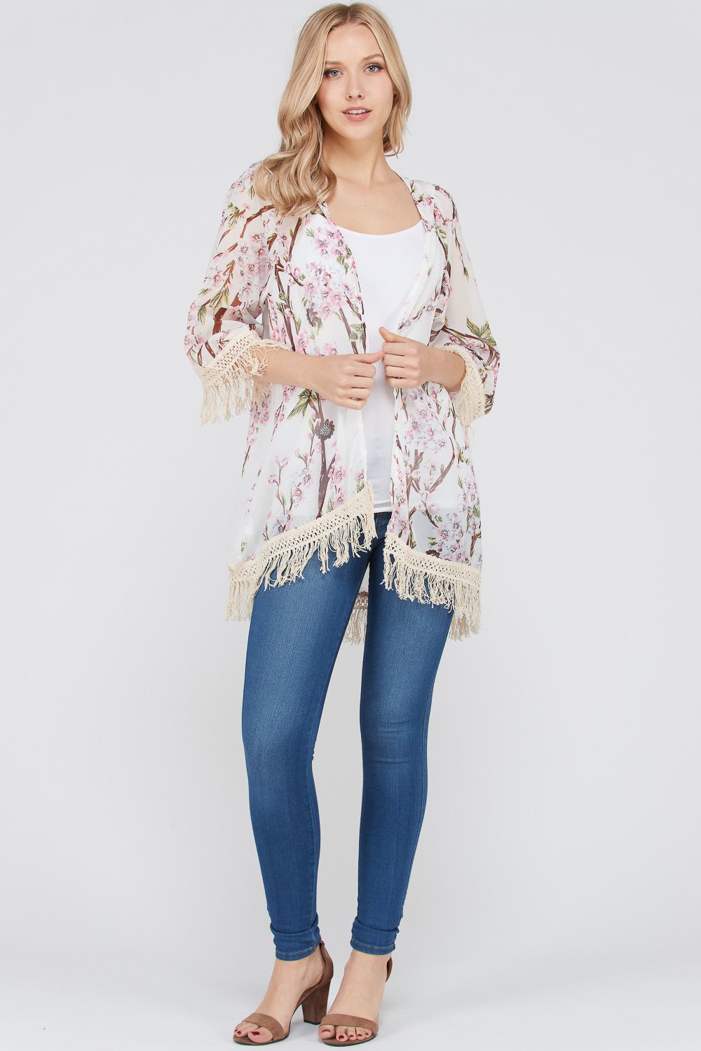 A stylish Women's 3/4 Sleeve Floral Printed Fringe Cardigan featuring a vibrant floral pattern and trendy fringe detailing at the bottom.