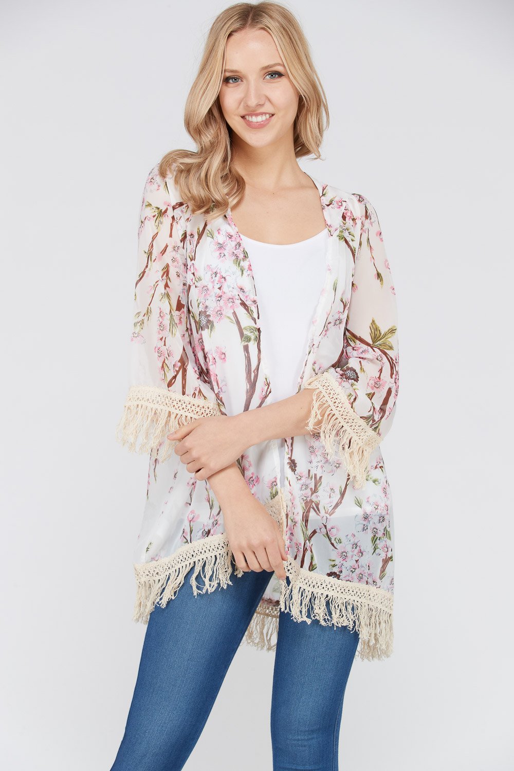 A stylish Women's 3/4 Sleeve Floral Printed Fringe Cardigan featuring a vibrant floral pattern and trendy fringe detailing at the bottom.