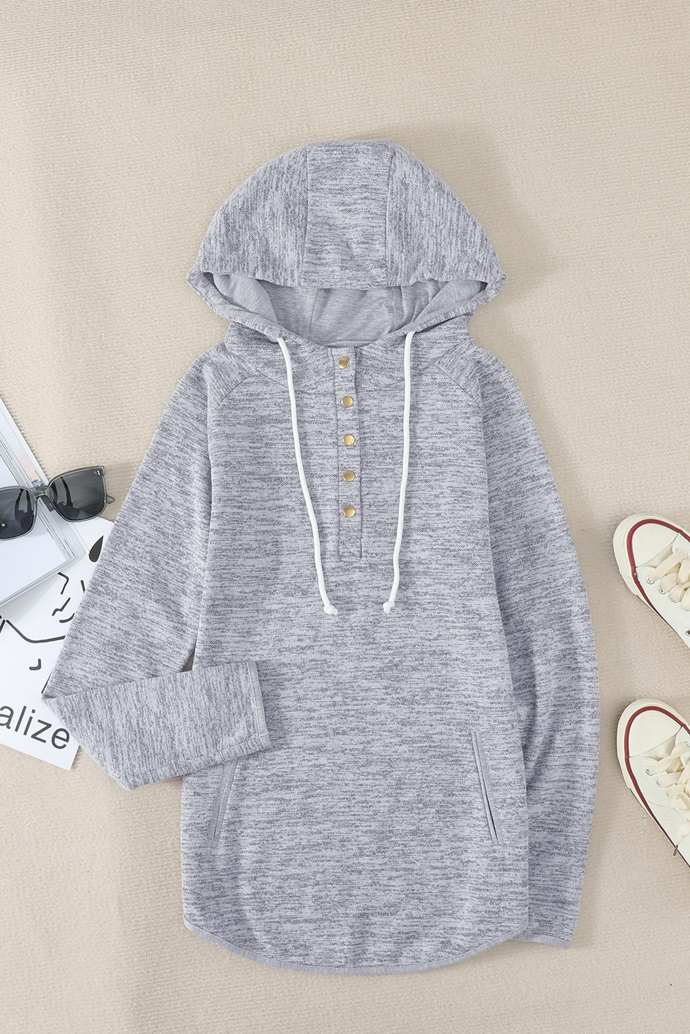 Women's gray casual hoodie featuring a pocket design and buttoned front, perfect for stylish comfort.