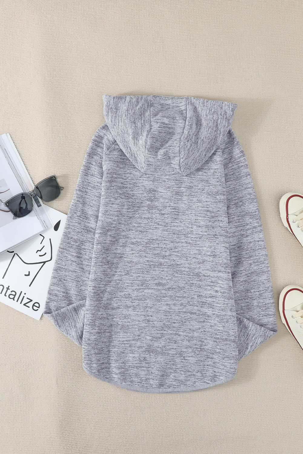 Women's gray casual hoodie featuring a pocket design and buttoned front, perfect for stylish comfort.