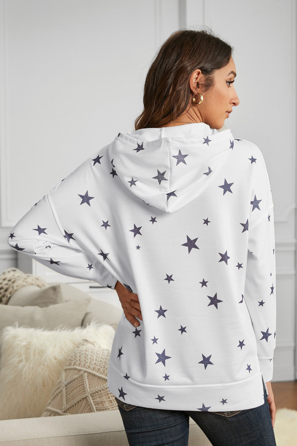 Women's white hoodie featuring side slits and a chic star print design, perfect for casual wear.