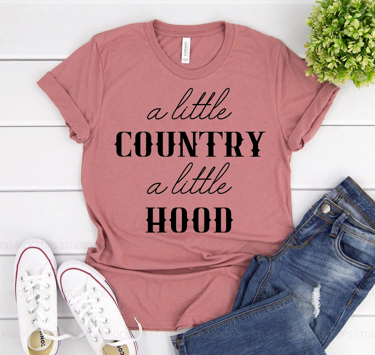 A Little Country A Little Hood Shirt displayed on a hanger, showcasing its soft fabric and unisex design.