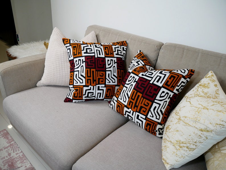 A pair of handmade African mudcloth pillow covers featuring intricate tribal patterns on soft cotton fabric, perfect for home decor.