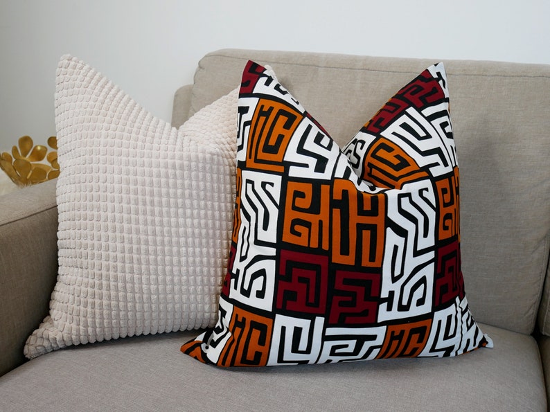 A pair of handmade African mudcloth pillow covers featuring intricate tribal patterns on soft cotton fabric, perfect for home decor.