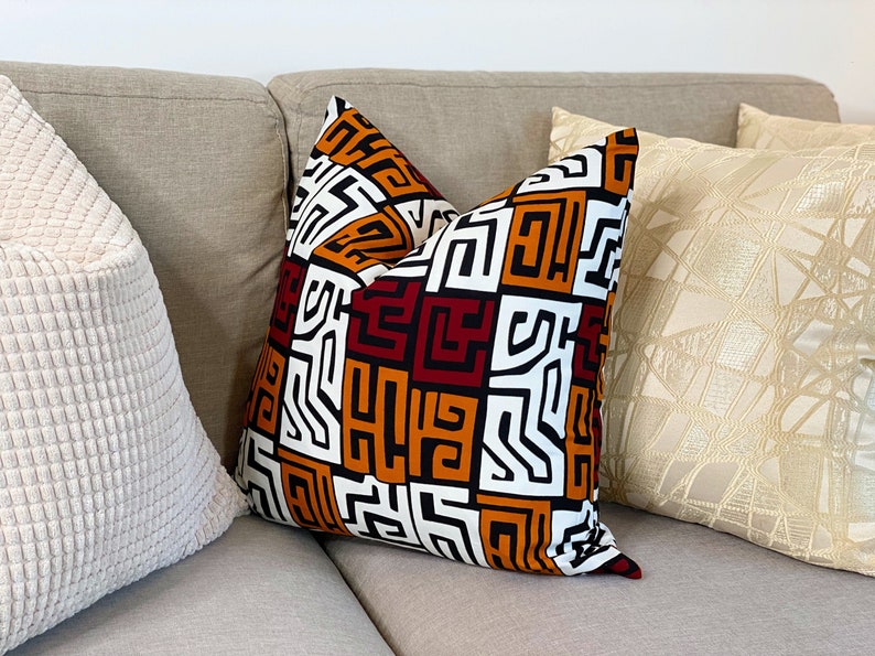 A pair of handmade African mudcloth pillow covers featuring intricate tribal patterns on soft cotton fabric, perfect for home decor.