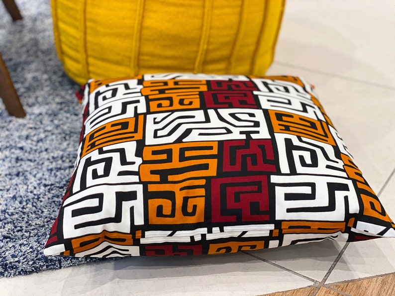 A pair of handmade African mudcloth pillow covers featuring intricate tribal patterns on soft cotton fabric, perfect for home decor.